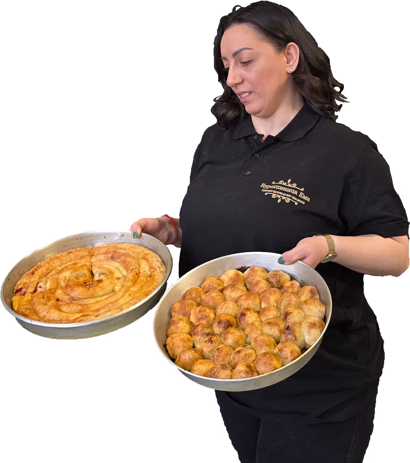 Woman in black shirt holding two round trays of freshly baked pastries, one with spiral pastry and the other with small round rolls.